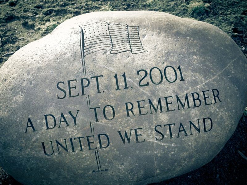 Memorial stone engraved with an American flag and the words "Sept. 11, 2001, A Day to Remember, United We Stand"